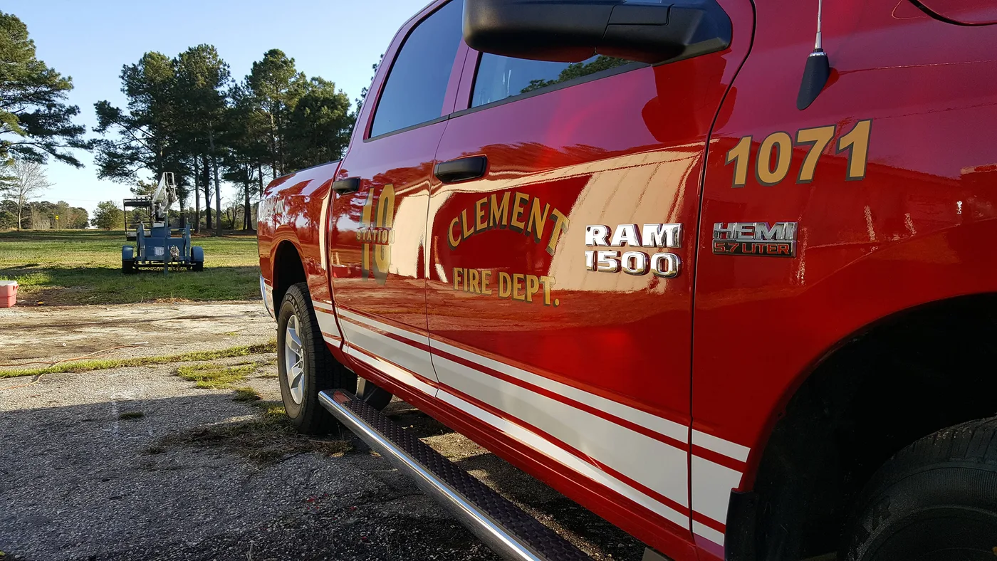Fire department truck with custom lettering by Famous Amos Signs
